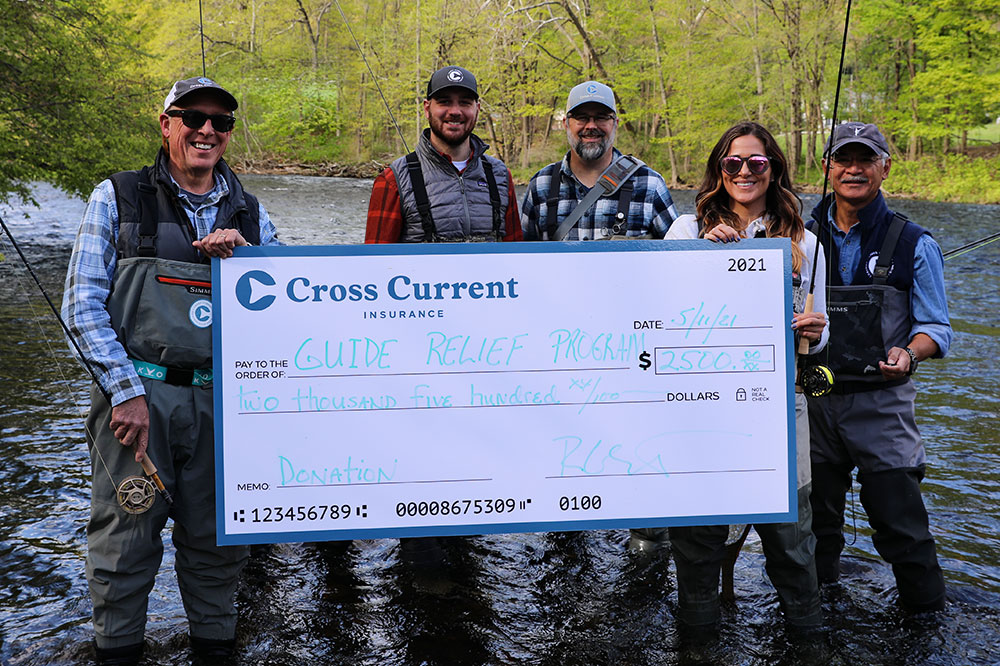 Cross Current Insurance team with Guide Relief Fund donation check
