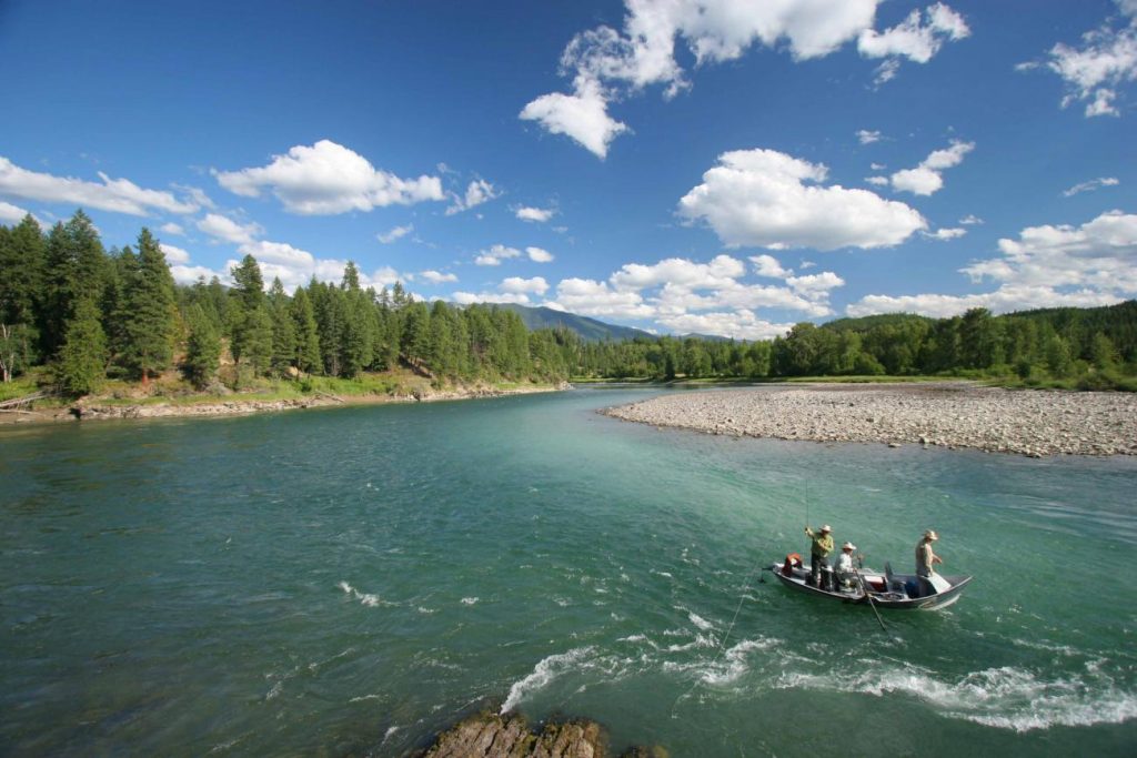 Fly fishing guide in drift boat on the river