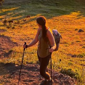 Woman hiker on a mountain with deer