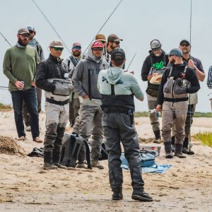 Anglers receiving lessons on safe catch and release techniques on a Cape Cod beach.