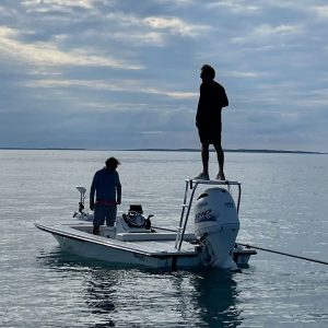 Fly fishing angler and a guide on a skiff in the ocean